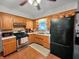 Functional kitchen with stainless steel appliances and wood cabinetry at 1331 Dunlap Ave, Indianapolis, IN 46241
