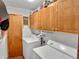Functional laundry room with washer, dryer, overhead cabinets, and a well-lit, organized space at 1331 Dunlap Ave, Indianapolis, IN 46241