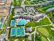 Aerial view showcases a community clubhouse with pool, tennis courts, parking, and meticulously landscaped grounds at 1333 Chatham Rdg Ct, Westfield, IN 46074