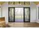 Balcony with a wooden deck and glass railings showcasing views of the lawn and trees at 1333 Chatham Rdg Ct, Westfield, IN 46074