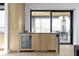 Modern bar area with a built-in wine cooler and access to an outdoor patio at 1333 Chatham Rdg Ct, Westfield, IN 46074