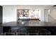 Stylish basement bar with marble backsplash, sleek countertops, and modern bar stools, ideal for entertaining guests at 1333 Chatham Rdg Ct, Westfield, IN 46074