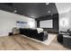 Finished basement with a large screen, plush seating, hardwood floors, and modern lighting for ultimate relaxation at 1333 Chatham Rdg Ct, Westfield, IN 46074