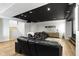 Finished basement with cozy black leather seating, a modern wet bar, hardwood floors, and a staircase at 1333 Chatham Rdg Ct, Westfield, IN 46074