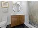 Modern bathroom featuring a stylish vanity, round mirror, and a glass-enclosed shower with decorative tile at 1333 Chatham Rdg Ct, Westfield, IN 46074