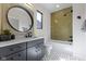 Modern bathroom boasts of stylish vanity, round mirror, and eye-catching tile shower at 1333 Chatham Rdg Ct, Westfield, IN 46074
