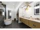 Modern bathroom showcasing a soaking tub, double vanity, and designer light fixtures at 1333 Chatham Rdg Ct, Westfield, IN 46074