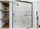 Elegant bathroom featuring a glass shower with marble walls and a shelf at 1333 Chatham Rdg Ct, Westfield, IN 46074