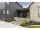 Home's front entrance with stone and black siding, modern design, and professional landscaping at 1333 Chatham Rdg Ct, Westfield, IN 46074