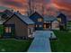 Beautiful exterior of this two-story home with long driveway, manicured lawn, and modern design at dusk at 1333 Chatham Rdg Ct, Westfield, IN 46074
