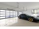 A luxury sports car is parked in a spacious garage with bright lighting and modern garage doors at 1333 Chatham Rdg Ct, Westfield, IN 46074