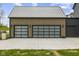 Attached garage with modern glass doors and concrete driveway at 1333 Chatham Rdg Ct, Westfield, IN 46074