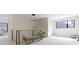 Hallway features a metal banister, modern light fixture, and neutral carpeting at 1333 Chatham Rdg Ct, Westfield, IN 46074