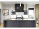 Modern kitchen with a large island, black accents, and sleek appliances at 1333 Chatham Rdg Ct, Westfield, IN 46074