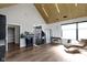 Open-concept living area featuring a unique light fixture, hardwood floors, and a stylish chaise lounge at 1333 Chatham Rdg Ct, Westfield, IN 46074