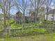 A view of the home from the treeline, showcasing the architecture and backyard landscaping at 1333 Chatham Rdg Ct, Westfield, IN 46074