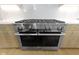 Close-up of a stainless steel Miele stove with six burners and double ovens at 1333 Chatham Rdg Ct, Westfield, IN 46074