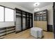 Custom walk-in closet with cabinets, shelves, drawers, and center ottoman at 1333 Chatham Rdg Ct, Westfield, IN 46074
