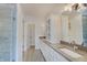 Modern bathroom with glass enclosed shower, dual sinks, and spacious vanity at 13392 Dorster St, Fishers, IN 46037
