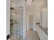 Modern bathroom with glass enclosed shower, dual sinks and vanity, and recessed lighting at 13392 Dorster St, Fishers, IN 46037
