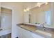 Bright bathroom featuring a double vanity with white cabinets and large mirror at 13392 Dorster St, Fishers, IN 46037