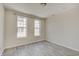 Bright bedroom featuring two large windows, wood-look floors, and neutral paint at 13392 Dorster St, Fishers, IN 46037