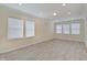 Spacious bonus room featuring wood-look floors and ample natural light from multiple windows at 13392 Dorster St, Fishers, IN 46037
