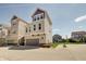 Exterior view of townhomes with attached garages, manicured lawns, and a sunny blue sky at 13392 Dorster St, Fishers, IN 46037