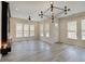 Bright open-concept living area with fireplace and large windows at 13392 Dorster St, Fishers, IN 46037