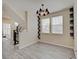 Open-concept floorplan features wood floors, two windows, and black staircase at 13392 Dorster St, Fishers, IN 46037