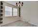 Bright living room with wood floors, two windows, and a modern light fixture at 13392 Dorster St, Fishers, IN 46037
