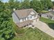 Aerial view of a beautiful home featuring a well-manicured lawn and mature trees at 13562 Silver Spur, Carmel, IN 46032