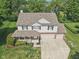 An aerial view of a two-story house with front porch and ample parking at 13562 Silver Spur, Carmel, IN 46032