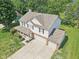 Aerial view of two-story house with brick and vinyl siding, mature trees, and large driveway at 13562 Silver Spur, Carmel, IN 46032
