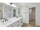Bright bathroom featuring double sink vanity with black hardware, shower and natural light at 13562 Silver Spur, Carmel, IN 46032