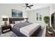 This staged bedroom features neutral walls and carpet, a ceiling fan, and natural light at 13562 Silver Spur, Carmel, IN 46032