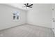 Neutral carpeted bedroom features bright window and ceiling fan at 13562 Silver Spur, Carmel, IN 46032