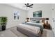 Bright bedroom with modern furnishings, neutral colors, and sleek ceiling fan at 13562 Silver Spur, Carmel, IN 46032