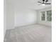 Spacious bedroom featuring neutral carpeting, ceiling fan, and well-lit window with attractive view at 13562 Silver Spur, Carmel, IN 46032