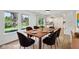 Dining room featuring modern furniture and a bright view to the exterior and open to a modern kitchen at 13562 Silver Spur, Carmel, IN 46032
