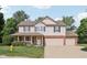 Charming two-story home with brick accents, shutters, and a well-maintained front yard and a two car garage at 13562 Silver Spur, Carmel, IN 46032