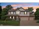 Two-story home with a covered front porch, brick accents, a large garage and mature trees on a large lot at 13562 Silver Spur, Carmel, IN 46032