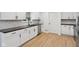 Charming kitchen boasting black hardware, butcher block counters, and white cabinetry at 13562 Silver Spur, Carmel, IN 46032