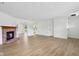 Spacious living area with brick fireplace, light floors, and an open layout offering backyard views and connecting spaces at 13562 Silver Spur, Carmel, IN 46032