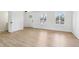 Bright, airy living space with modern wood-look floors, white walls, and windows with natural light at 13562 Silver Spur, Carmel, IN 46032