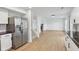 Open floorplan from stainless steel kitchen to living room with wood floors and fireplace at 13562 Silver Spur, Carmel, IN 46032