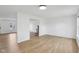 Bright living space with light wood-look flooring, neutral walls, and seamless transition to other living areas at 13562 Silver Spur, Carmel, IN 46032
