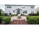 Backyard patio with a fire pit, and a covered porch, surrounded by manicured landscaping and a spacious lawn at 13717 Van Buren Pl, Fishers, IN 46038