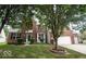 Charming two-story brick home featuring a well-manicured lawn and mature trees, creating an inviting curb appeal at 13717 Van Buren Pl, Fishers, IN 46038
