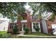 Inviting two-story home with a brick facade, complemented by a well-maintained lawn and lush landscaping at 13717 Van Buren Pl, Fishers, IN 46038